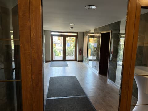 Building entrance hall with a tiled floor and doormats